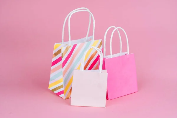 Paper shopping or gift bags on pink background with copy spa��e. — Stock Photo, Image