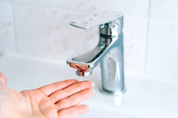 Washing hands person for coronavirus prevention, hygiene to stop spreading covid-19 in bathroom. Washing hands under under running water tap or faucet without soap. Hygiene and protection concept — Stock Photo, Image