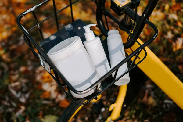 Bicycle basket with cosmetic jars. Self-care in the fall