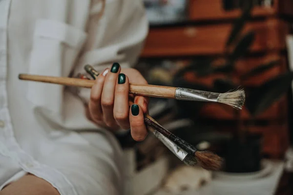 Primer plano de artista femenina sosteniendo pincel de mano —  Fotos de Stock