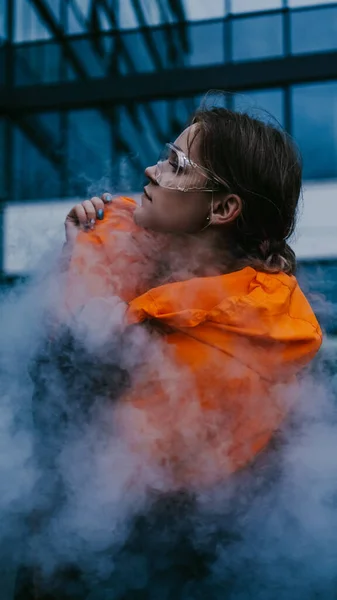 Girl in protective overalls and glasses. Air pollution and hazard concept — ストック写真