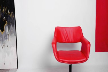 Modern red armchair on a white background in studio