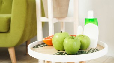 Organic orange and green apples on the natural wooden table. Health food concept