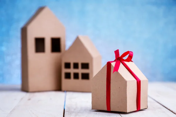 Gift wrapping of cardboard tied with a red ribbon — Stock Photo, Image