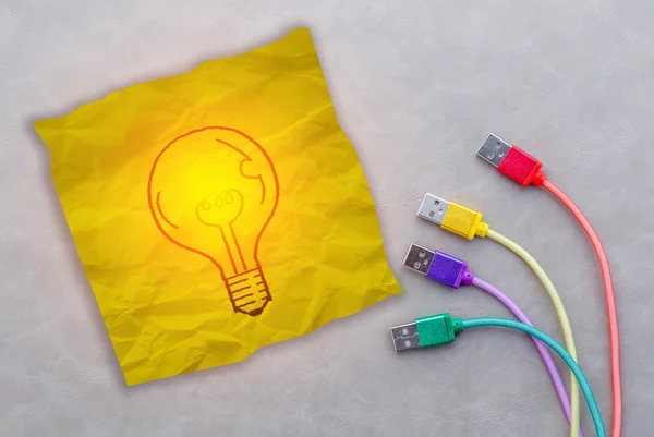 Drawing of glowing bulb on yellow note paper — Stock Photo, Image