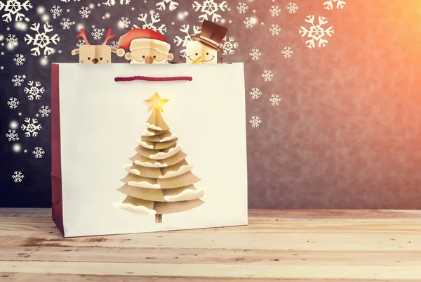 Festive white paper-bag with christmas tree, snowflakes and chri