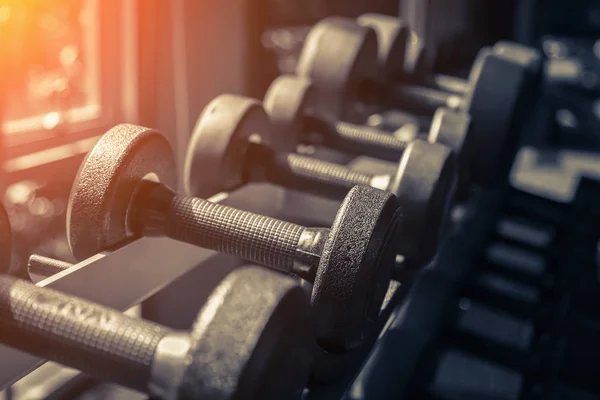 Rows of dumbbells in the gym with hign contrast and monochrome c