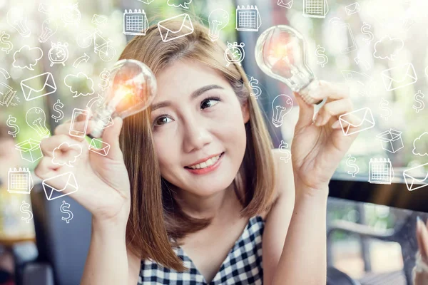 asian smart beauty girl with glow light bulb with drawing of light bulb in cafe creativity ideas concept