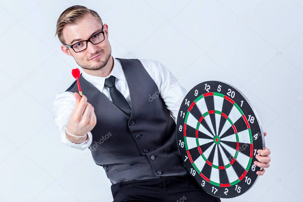 Business Man hand holding a target with darts hitting the center over white background. Concept of personal coaching success