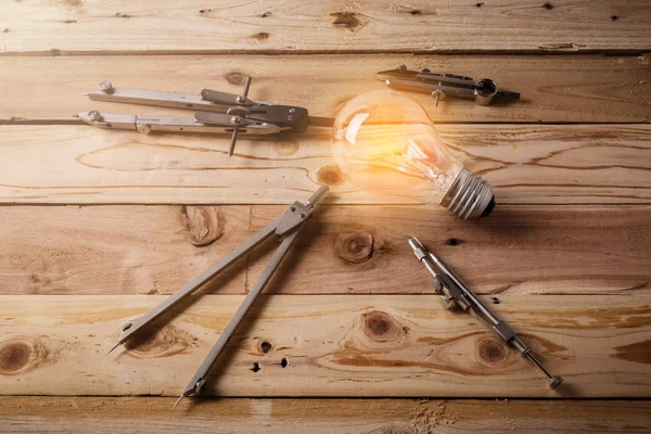 drawing tool with glow light bulb on leather background creativity  ideas concept