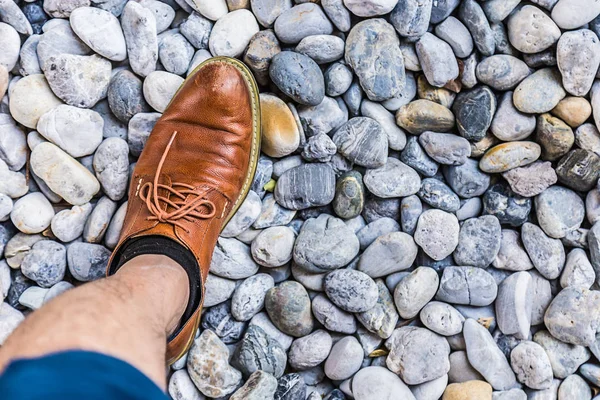 Men leather shoe on round pebble stone background — Stock Photo, Image