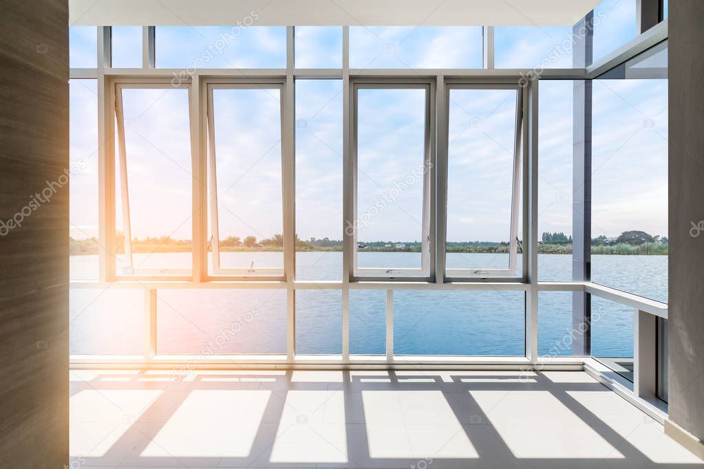 white window frame with nature lake view at apartment on sunny day background for freedom concept