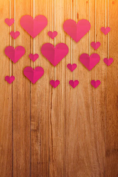 Hand cut hearts on wood texture background