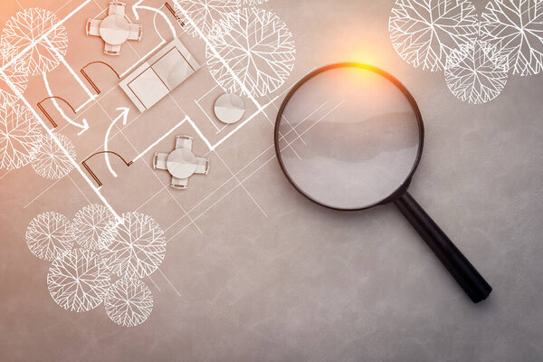 house design concept with drawing of design with magnifying glass