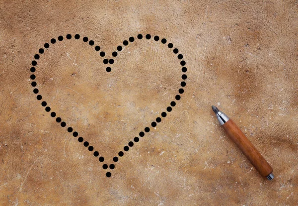 love concept with pencil on brown background