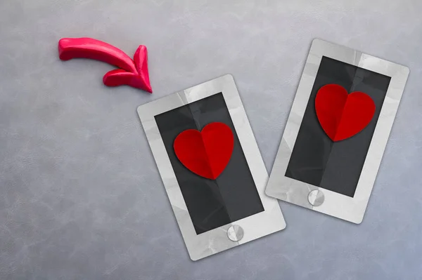 Online dating app concept with smart phone and heart shape paper.