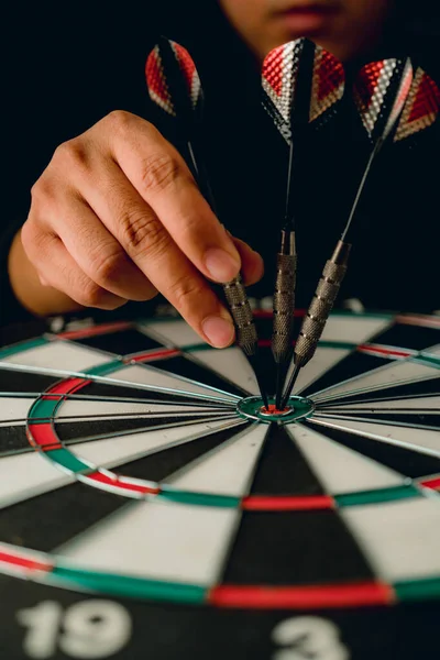 red arrow dart board with hand hold closeup business strategy  concept aim for goal target with retro matte tone retro style