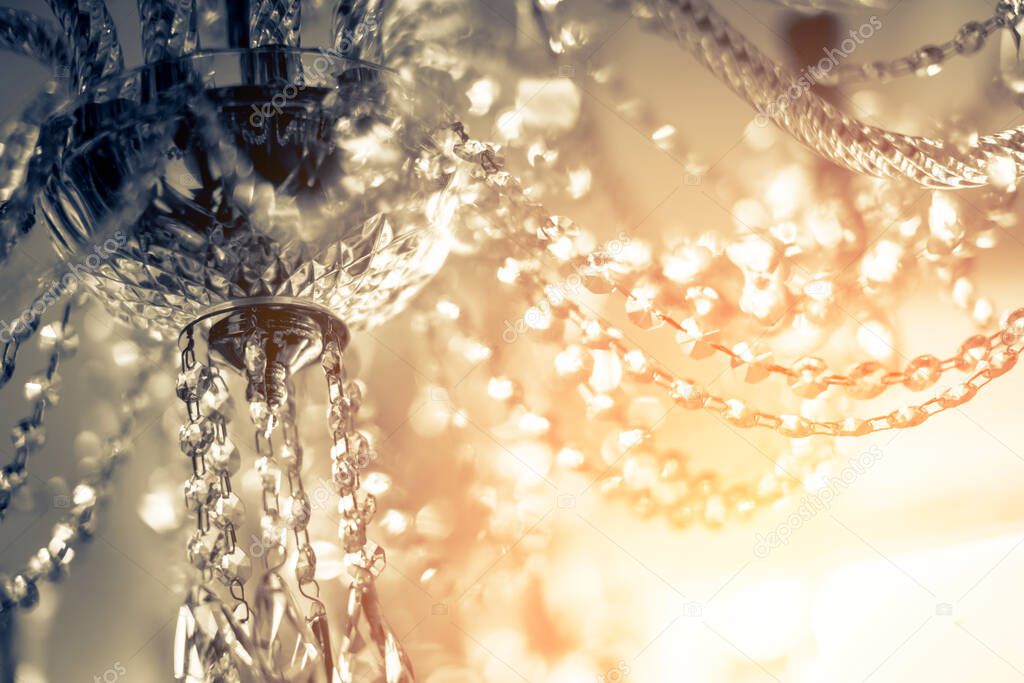 abstract image background of blur bokeh and crystal chandelier light equipment filter tone color effect