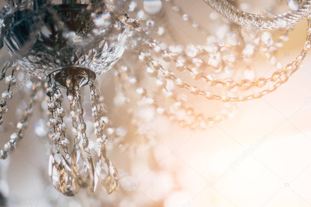 abstract image background of blur bokeh and crystal chandelier light equipment filter tone color effect