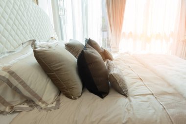 Yatak odasında temiz beyaz yastıkları ve çarşafları olan bir hizmetçi. Yakın plan. iç arkaplan