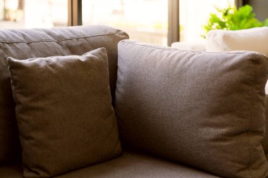 Yumuşak kumaş yastık dekorasyonunu oturma odasındaki güzel kanepenin ev tasarımı konseptinde kapat.