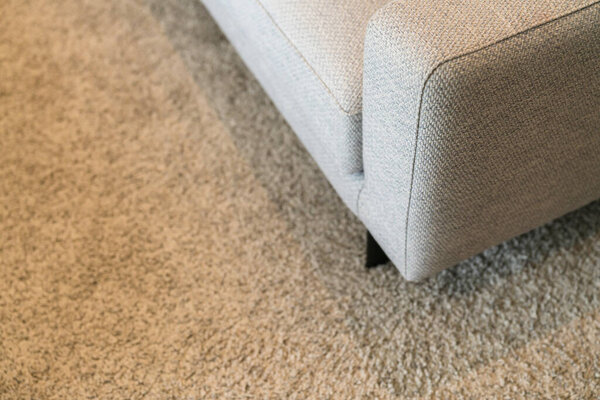 Synthetic carpet on the laminate in the home interior. Close-up