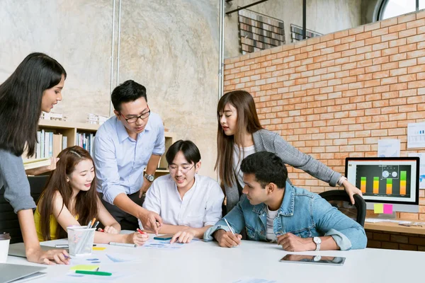 small group of creative startup business brainstorm meeting casual strategy direction together in moden office background