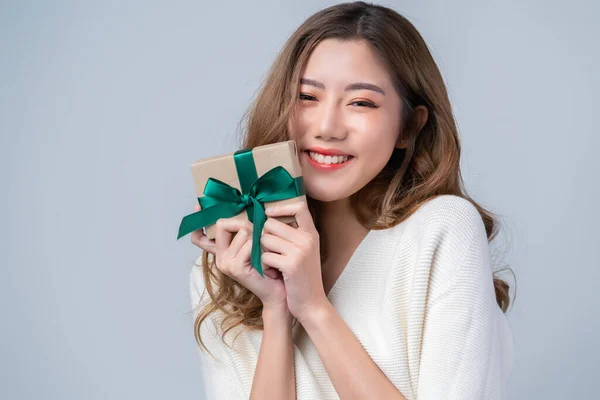 smart casual asian beautiful female smile hand show brown gift present box with ribbon with cheerful white background