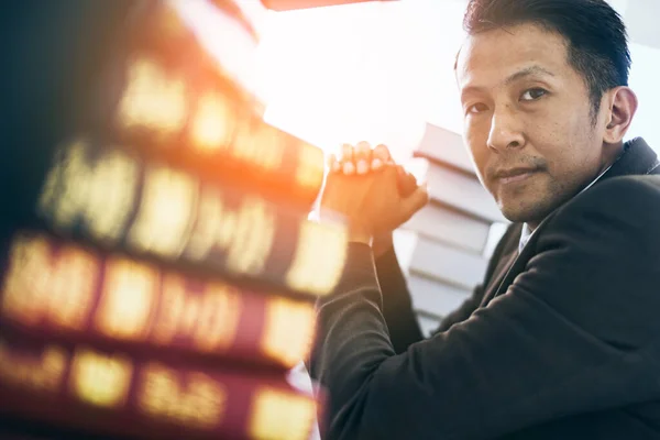 business asian man focus and thinking with money and project on table color tone image