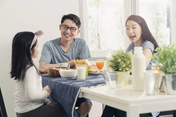 happiness asian family dad mom and daughter enjoy breakfast together on dining table wonderful moment family concept
