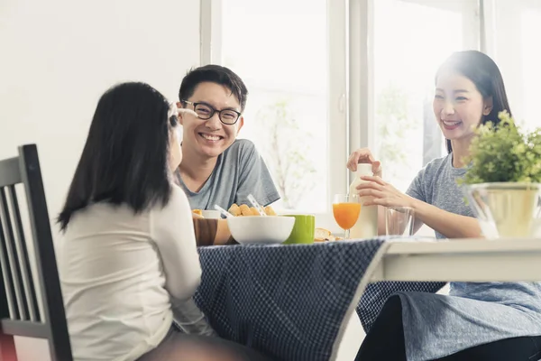 happiness asian family dad mom and daughter enjoy breakfast together on dining table wonderful moment family concept