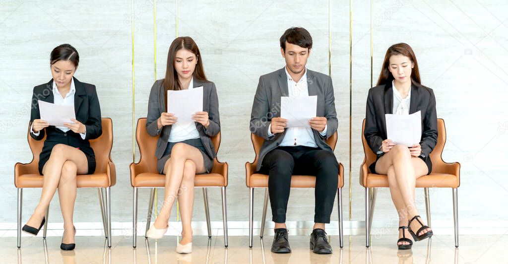 group of candidate asian business People sitting in a row, waiting in line for job interview