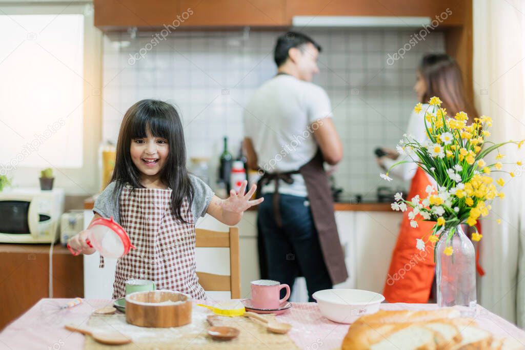 sweet family weekend activities cooking together with dad mom and daughter happiness moment and joyful hobby home kitchen background