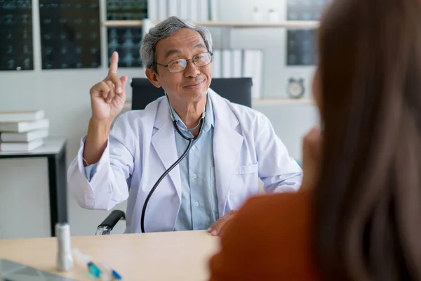 asian expert doctor examine and explain to asian woman patient with care and happiness health ideas concept