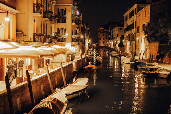 Evening view of canal with boats in Venice, Italy