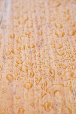 Yağmurdan sonra ahşap masa üstünde su damlaları