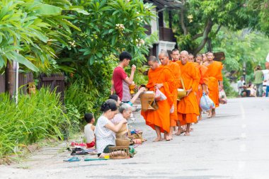 Luang Prabang, Laos - 14 Haziran 2015: sabah töreni Budist sadaka. Rahipler de Luang Prabang için sadaka verme geleneği turistlere genişletilmiş.
