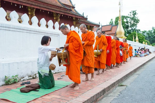 Luang Prabang, Laos - 14 Haziran 2015: sabah töreni Budist sadaka. Rahipler de Luang Prabang için sadaka verme geleneği turistlere genişletilmiş.