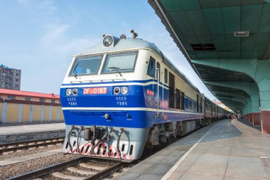 HEILONGJIANG, CHINA - Jul 24 2015: China Railways DF11 diesel locomotive in Mudanjiang Railway Station, Heilongjiang, China. DF11 used on the China Railway network. clipart