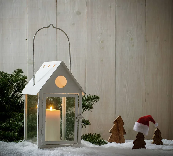 Lantern as house in snow with candle — Stock Photo, Image