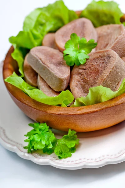 Boiled beef tongue and salad leaves