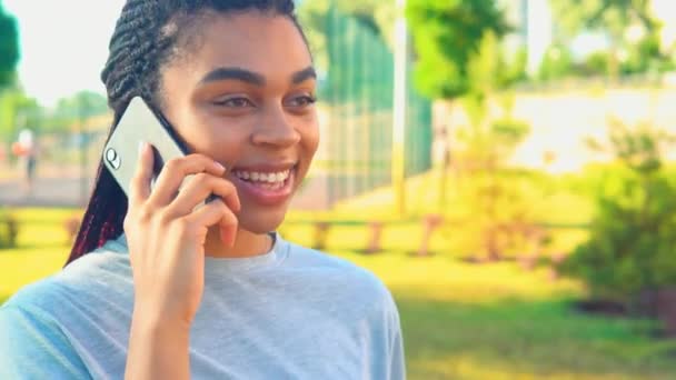 Close-up afrikaanse amerikaanse vrouw praten door telefoon buiten gelukkig levensstijl — Stockvideo