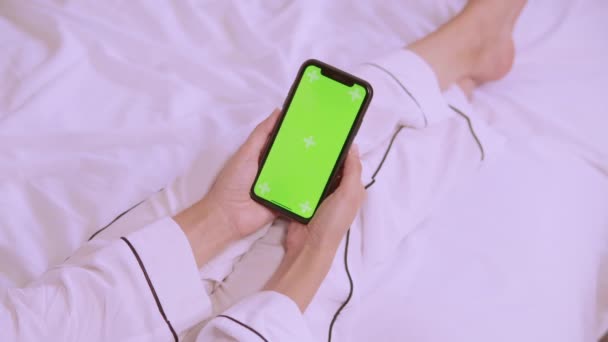 Детали female using device in bedroom in the morning — стоковое видео