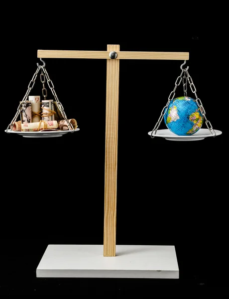 Earth and Money on a Two Pan Balance — Stock Photo, Image