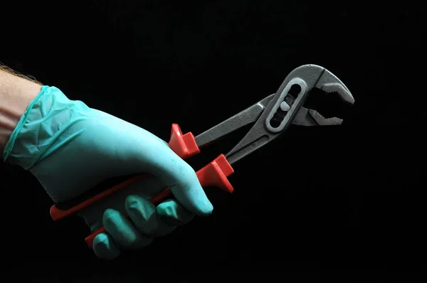 Pliers and a Hand — Stock Photo, Image