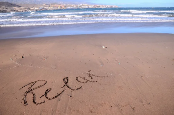 Slovo napsané na písku — Stock fotografie