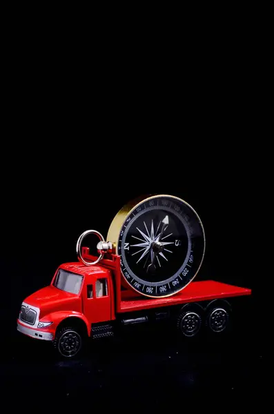 Orientation Transportation Concept Compass Red Toy Truck Black Background — Stock Photo, Image