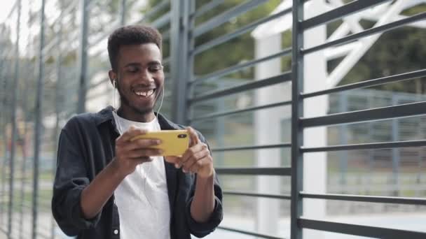 Hombre viendo vídeos en smartphone en auriculares . — Vídeos de Stock