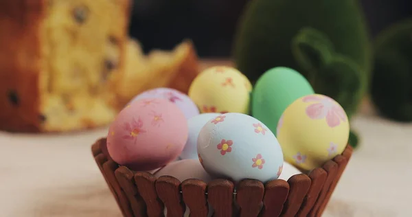 Menutup tangan ibu dan anak perempuan meletakkan telur Paskah dalam keranjang. Paskah. Persiapan untuk pesta Paskah Stok Gambar