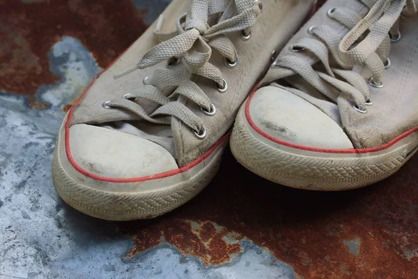 Old sneakers on zinc
